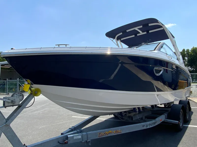 Slide: The Image of 2025 Cobalt R6 Outboard boat on trailer, sleek design, blue and white exterior. - 5