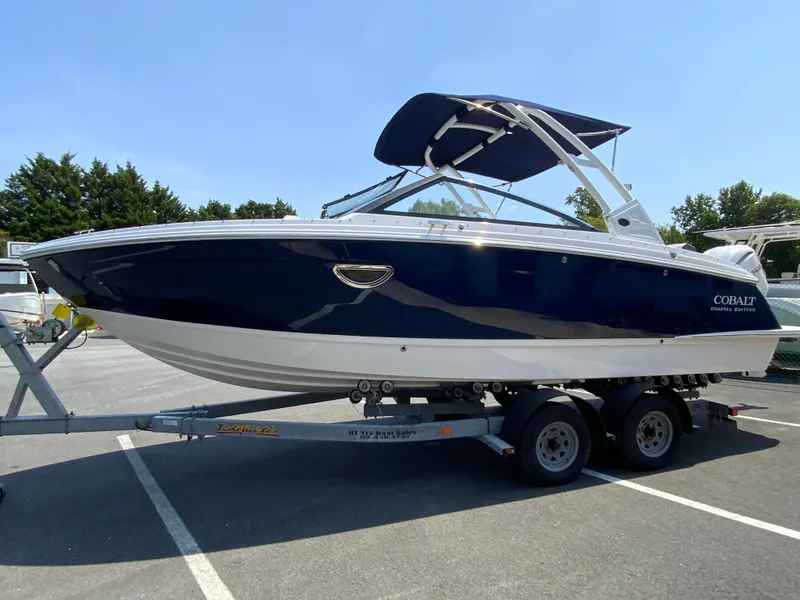 Slide: The Image of 2025 Cobalt R6 Outboard boat on trailer, parked in sunny lot. - 6
