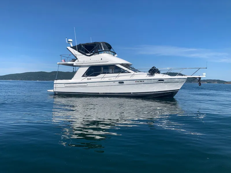The Image of 1996 Bayliner 3388 Command Bridge Motoryacht on calm waters. - 0