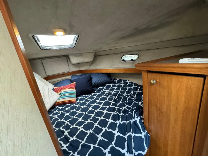 Slide: The Image of Cozy cabin interior of a 1996 Bayliner 3388 Command Bridge Motoryacht with bed and storage. - 10
