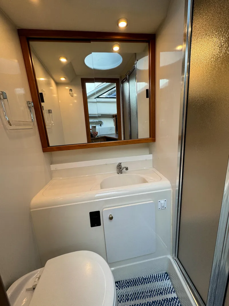 Slide: The Image of Bathroom of 1996 Bayliner 3388 Command Bridge Motoryacht with sink, mirror, and shower. - 15