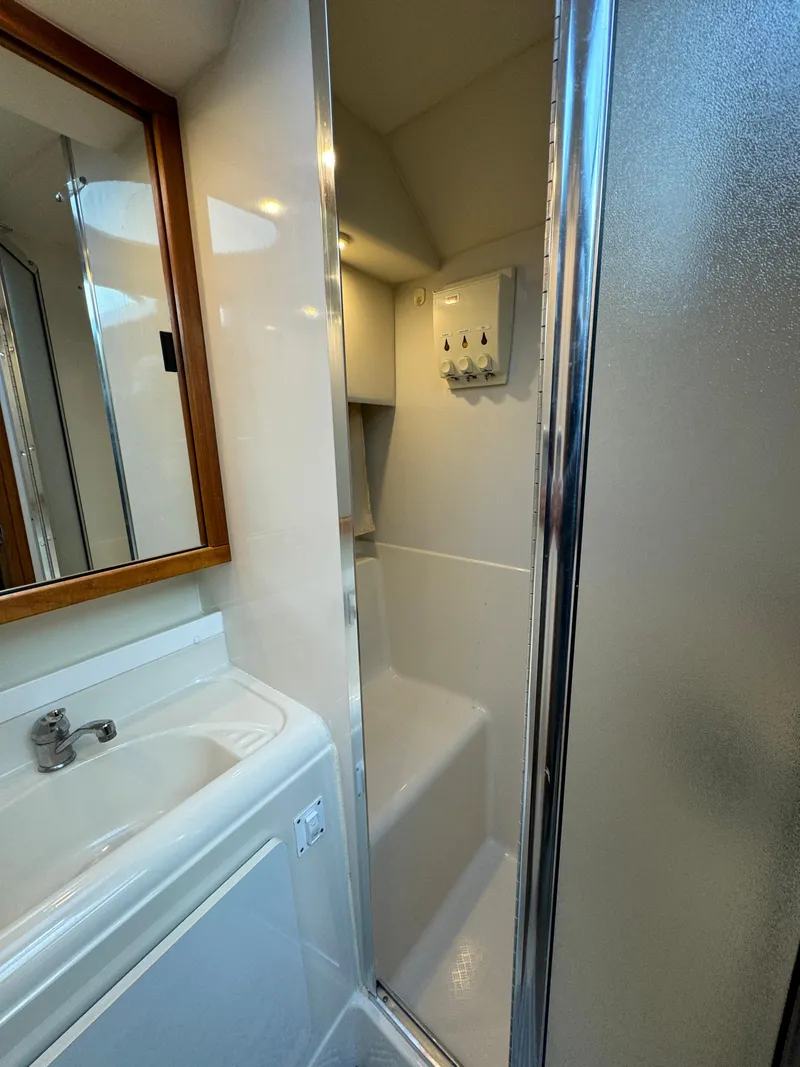 Slide: The Image of 1996 Bayliner 3388 Command Bridge Motoryacht bathroom with sink and shower. - 16