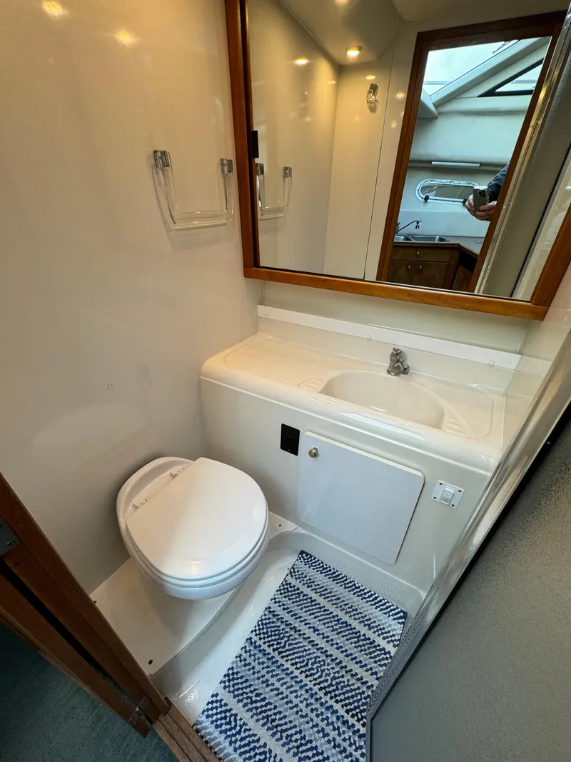 Slide: The Image of 1996 Bayliner 3388 Command Bridge Motoryacht bathroom with sink and toilet. - 18