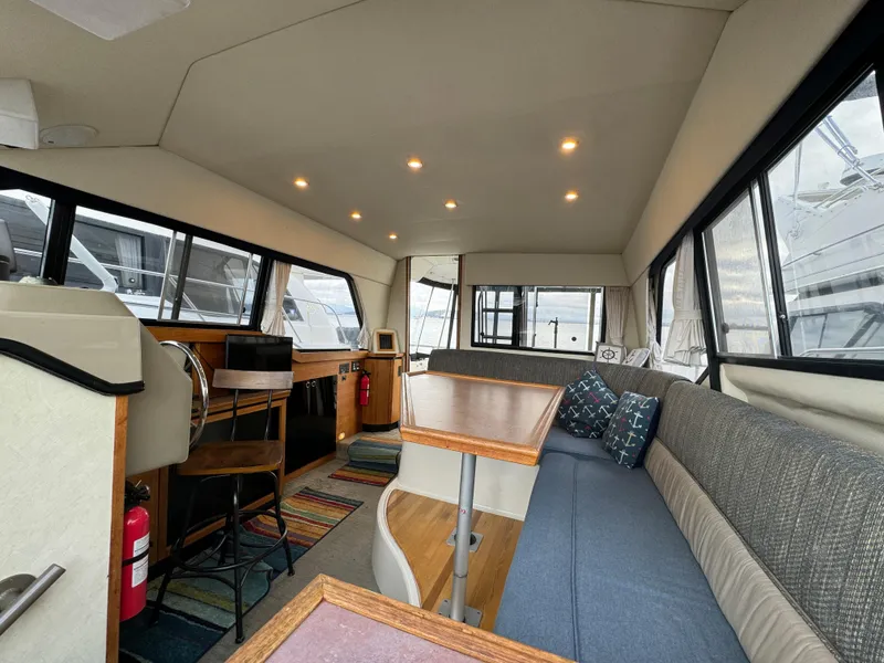 Slide: The Image of Interior of 1996 Bayliner 3388 Command Bridge Motoryacht with seating and dining area. - 19
