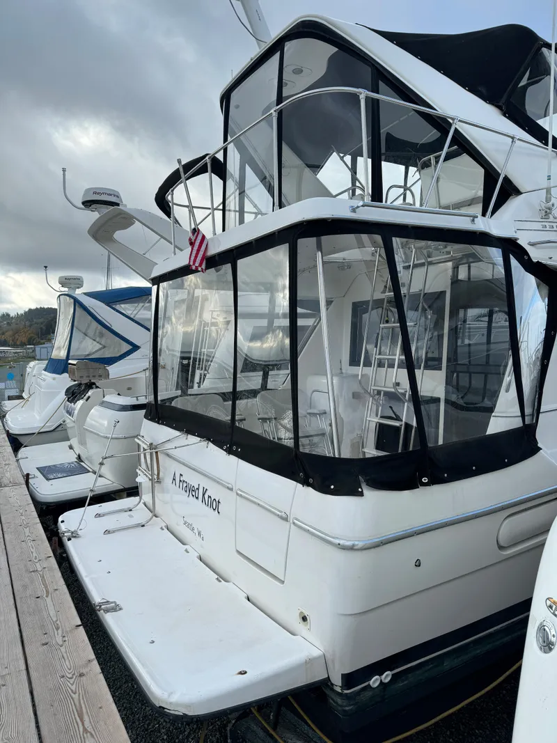 Slide: The Image of 1996 Bayliner 3388 Command Bridge Motoryacht docked at marina. - 2