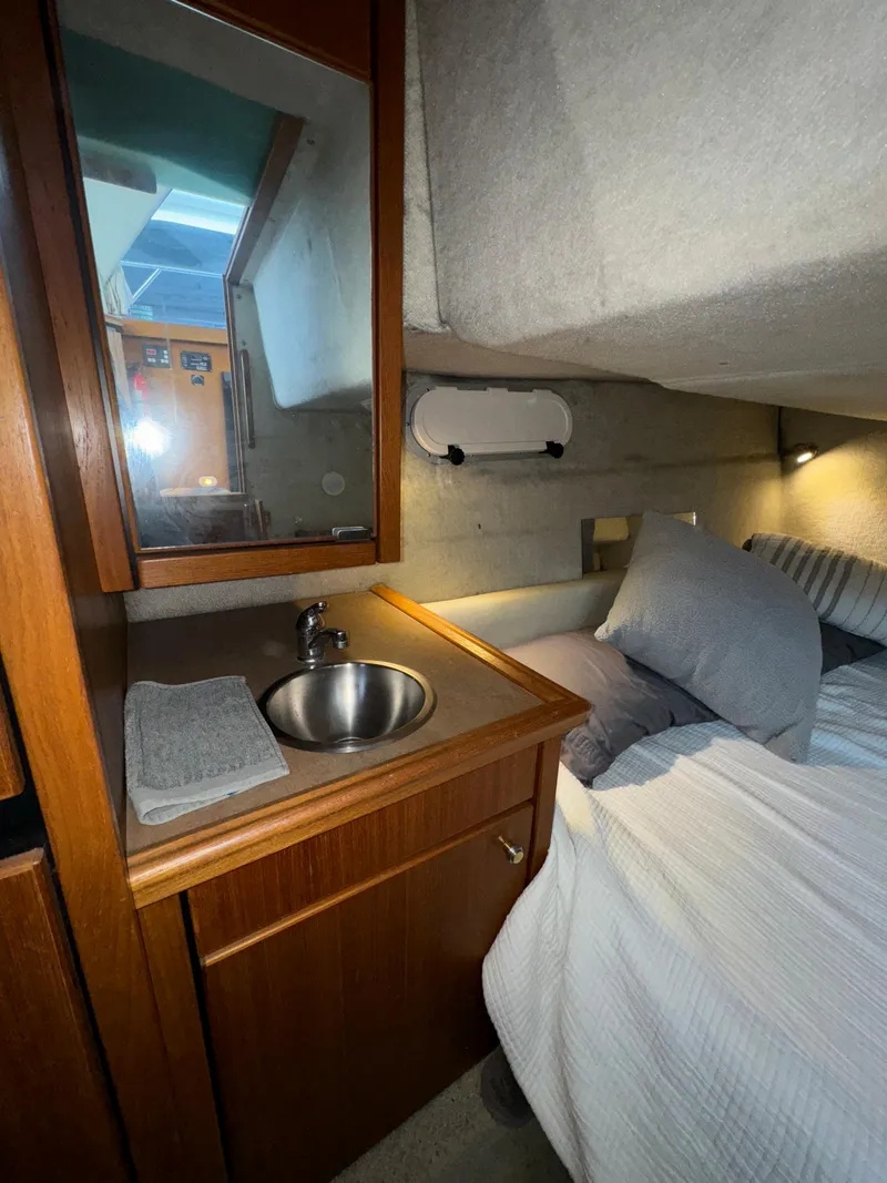 Slide: The Image of 1996 Bayliner 3388 Command Bridge Motoryacht cabin interior with sink and bed. - 21