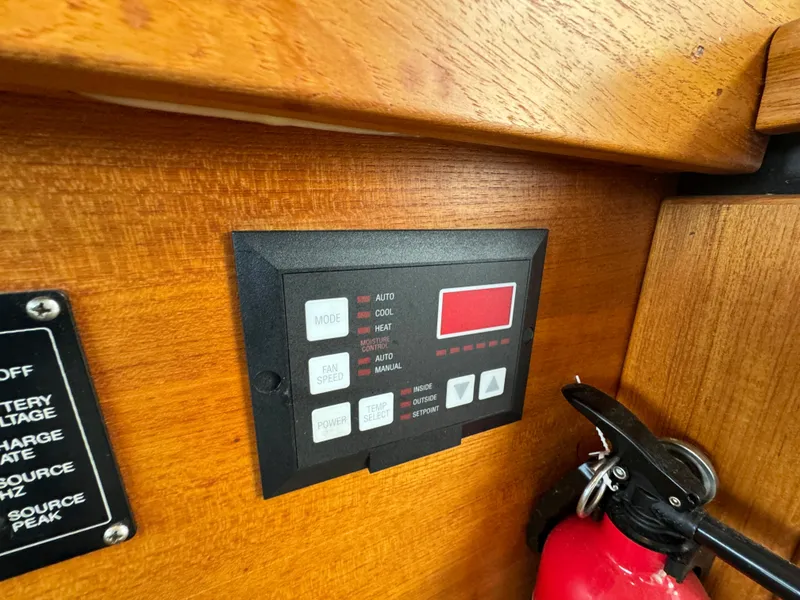 Slide: The Image of Control panel on a 1996 Bayliner 3388 Command Bridge Motoryacht with a fire extinguisher nearby. - 30