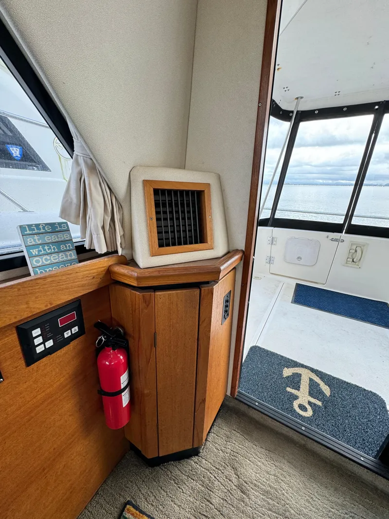 Slide: The Image of 1996 Bayliner 3388 Command Bridge Motoryacht interior with fire extinguisher and sea view. - 31