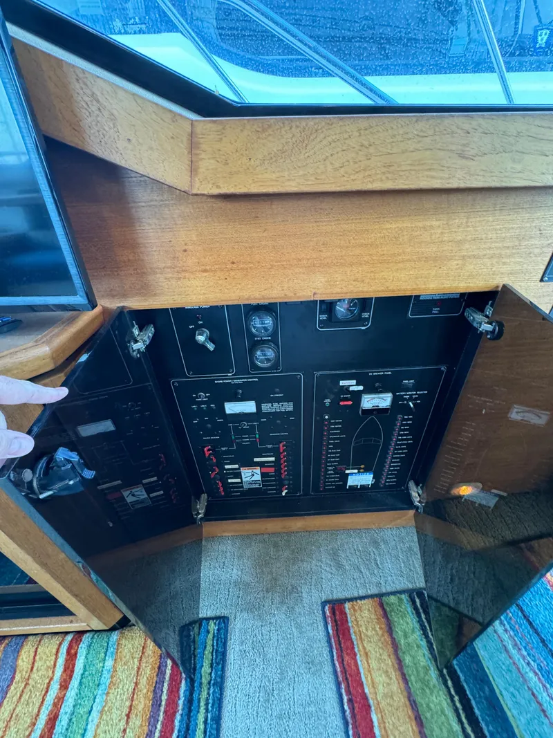 Slide: The Image of 1996 Bayliner 3388 Command Bridge Motoryacht control panel with open cabinet doors. - 32