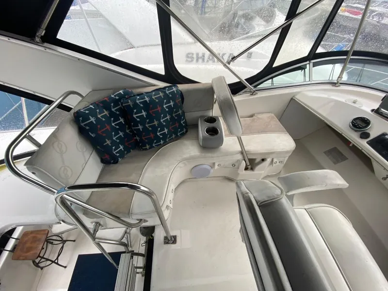 Slide: The Image of 1996 Bayliner 3388 Command Bridge Motoryacht interior with seating and helm station. - 33
