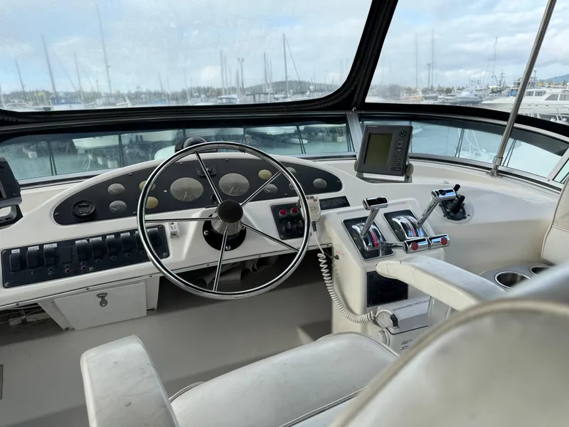 Slide: The Image of 1996 Bayliner 3388 Command Bridge Motoryacht helm with steering wheel and navigation equipment. - 36