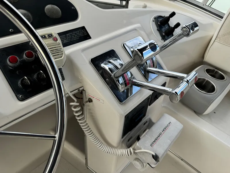 Slide: The Image of 1996 Bayliner 3388 Command Bridge Motoryacht helm controls and steering wheel. - 40