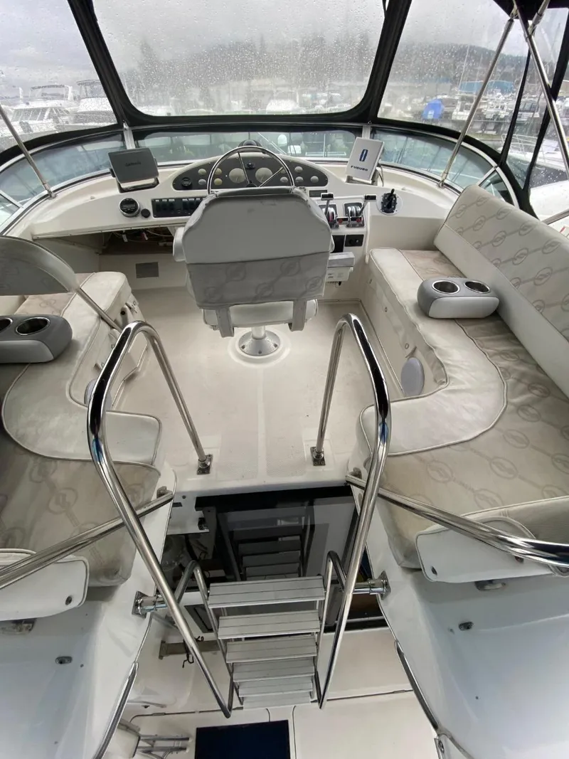 Slide: The Image of 1996 Bayliner 3388 Command Bridge Motoryacht helm with seating and navigation controls. - 43