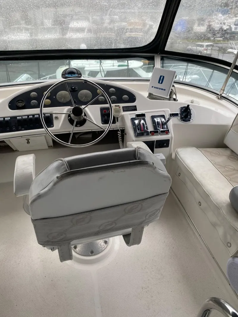 Slide: The Image of Interior helm of 1996 Bayliner 3388 Command Bridge Motoryacht with steering wheel and controls. - 44