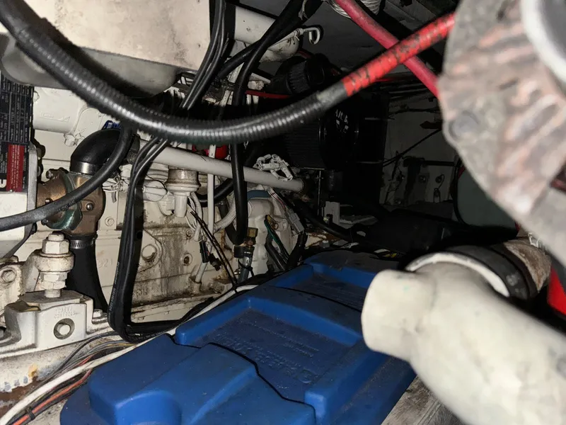 Slide: The Image of Engine compartment of a 1996 Bayliner 3388 Command Bridge Motoryacht with visible wiring and components. - 48