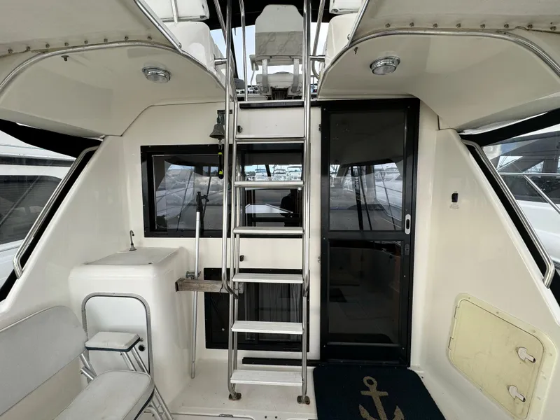 Slide: The Image of 1996 Bayliner 3388 Command Bridge Motoryacht interior with ladder and seating. - 6