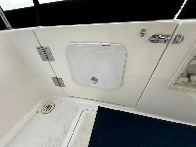 Slide: The Image of 1996 Bayliner 3388 Command Bridge Motoryacht deck with storage hatch and drain. - 9