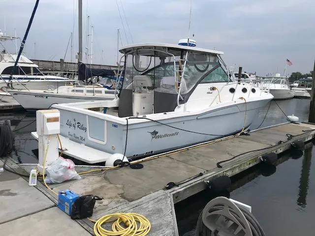 The Image of 2004 Wellcraft 330 Coastal boat docked at marina. - 0