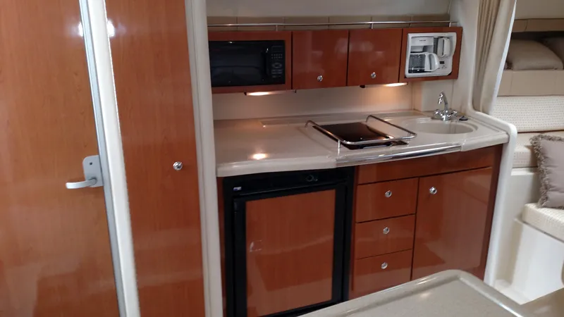 Slide: The Image of 2004 Wellcraft 330 Coastal boat with white outdoor seating. - 12