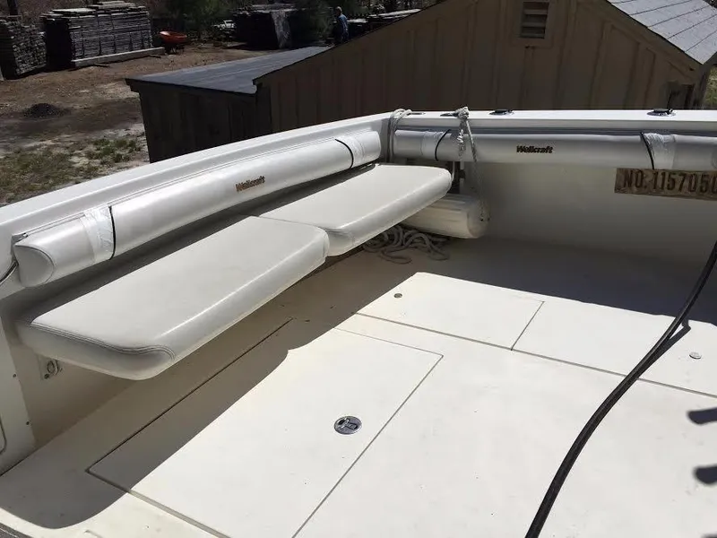 Slide: The Image of 2004 Wellcraft 330 Coastal helm with gauges and throttle controls. - 16