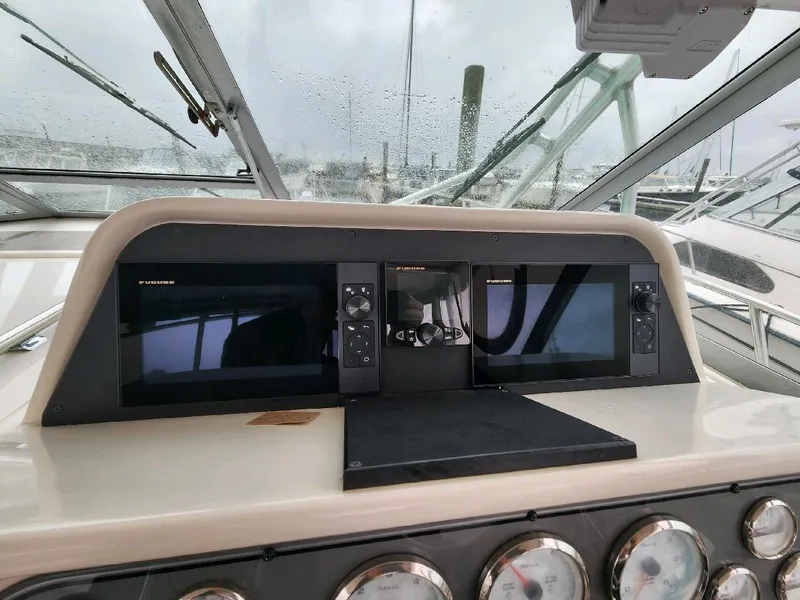Slide: The Image of 2004 Wellcraft 330 Coastal helm with instruments and steering wheel. - 18