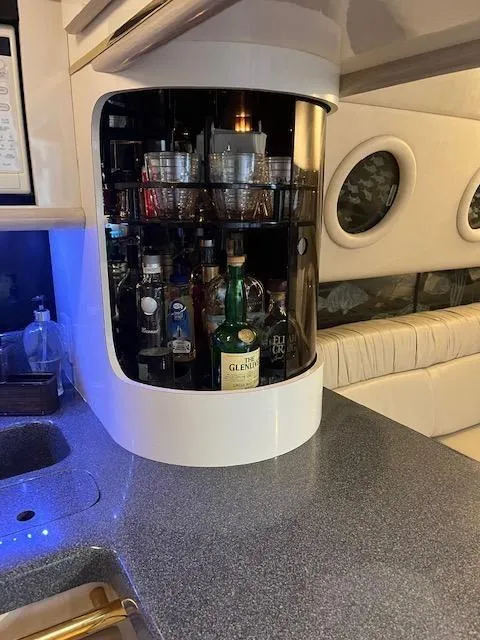 Slide: The Image of 1997 Sea Ray 500 Sundancer yacht interior with built-in bar and liquor bottles. - 15