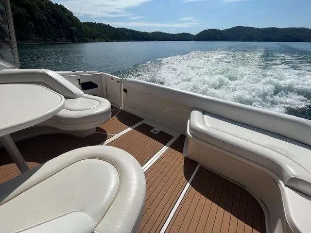 Slide: The Image of 1997 Sea Ray 500 Sundancer cruising on a lake with scenic mountain views. - 24
