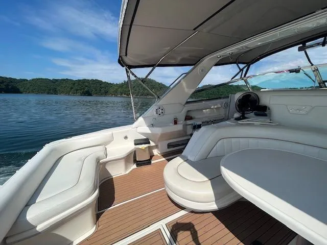 Slide: The Image of 1997 Sea Ray 500 Sundancer boat interior with seating and lake view. - 26