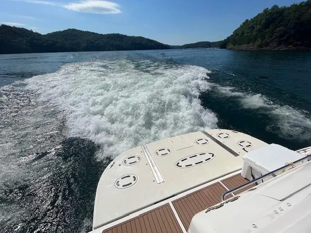 Slide: The Image of 1997 Sea Ray 500 Sundancer cruising on a scenic lake. - 27