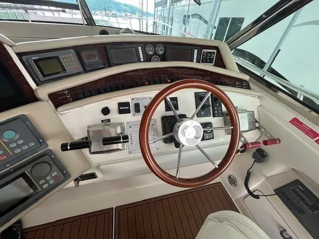 Slide: The Image of 1997 Sea Ray 500 Sundancer helm with wooden steering wheel and control panel. - 3