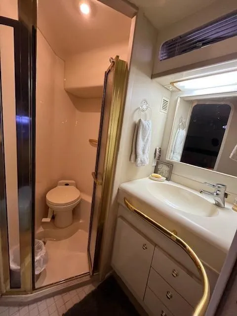 Slide: The Image of 1997 Sea Ray 500 Sundancer bathroom with shower, sink, and toilet. - 9