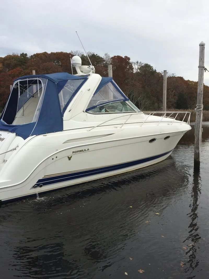 Slide: The Image of 2002 Formula 37 PC yacht docked in calm waters. - 2