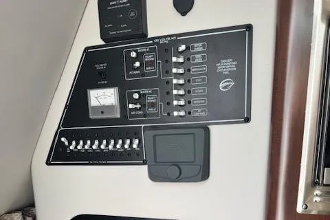 Slide: The Image of 2024 Crownline 270 CR control panel with switches and gauges. - 19
