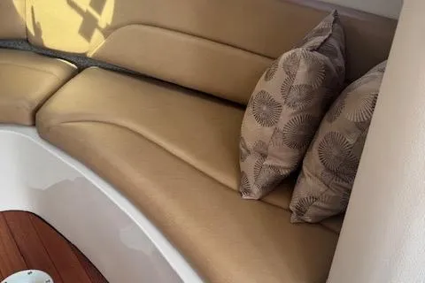 Slide: The Image of 2024 Crownline 270 CR interior with beige seating and patterned cushions. - 21