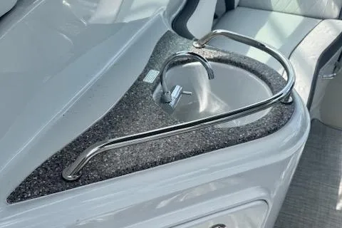 Slide: The Image of 2024 Crownline 270 CR boat sink with sleek countertop and modern faucet design. - 6