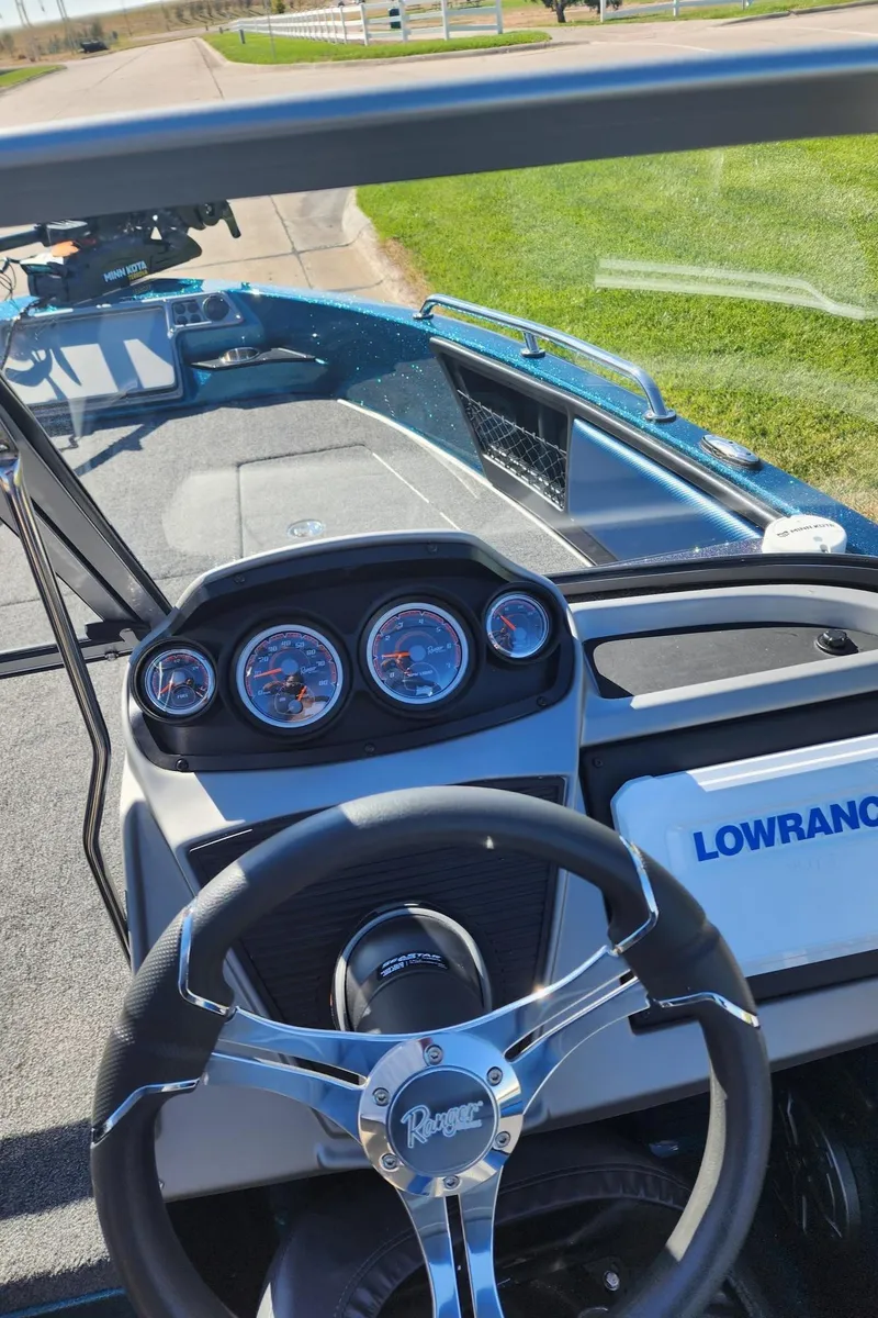 Slide: The Image of 2024 Ranger 1880MS boat dashboard with steering wheel and Lowrance electronics. - 8