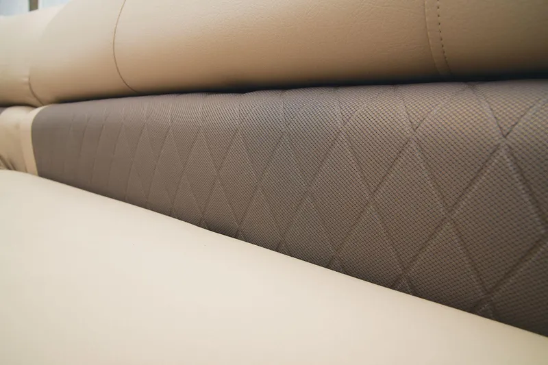 Slide: The Image of Close-up of 2024 Sun Tracker Party Barge 20 DLX beige and brown quilted upholstery. - 26