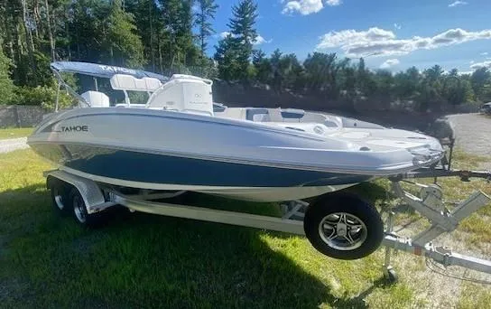 The Image of 2024 Tahoe 2150 CC boat on trailer, parked on grass under a sunny sky. - 0