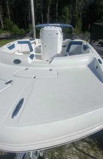 Slide: The Image of 2024 Tahoe 2150 CC boat, white deck, spacious seating, outdoor setting. - 3