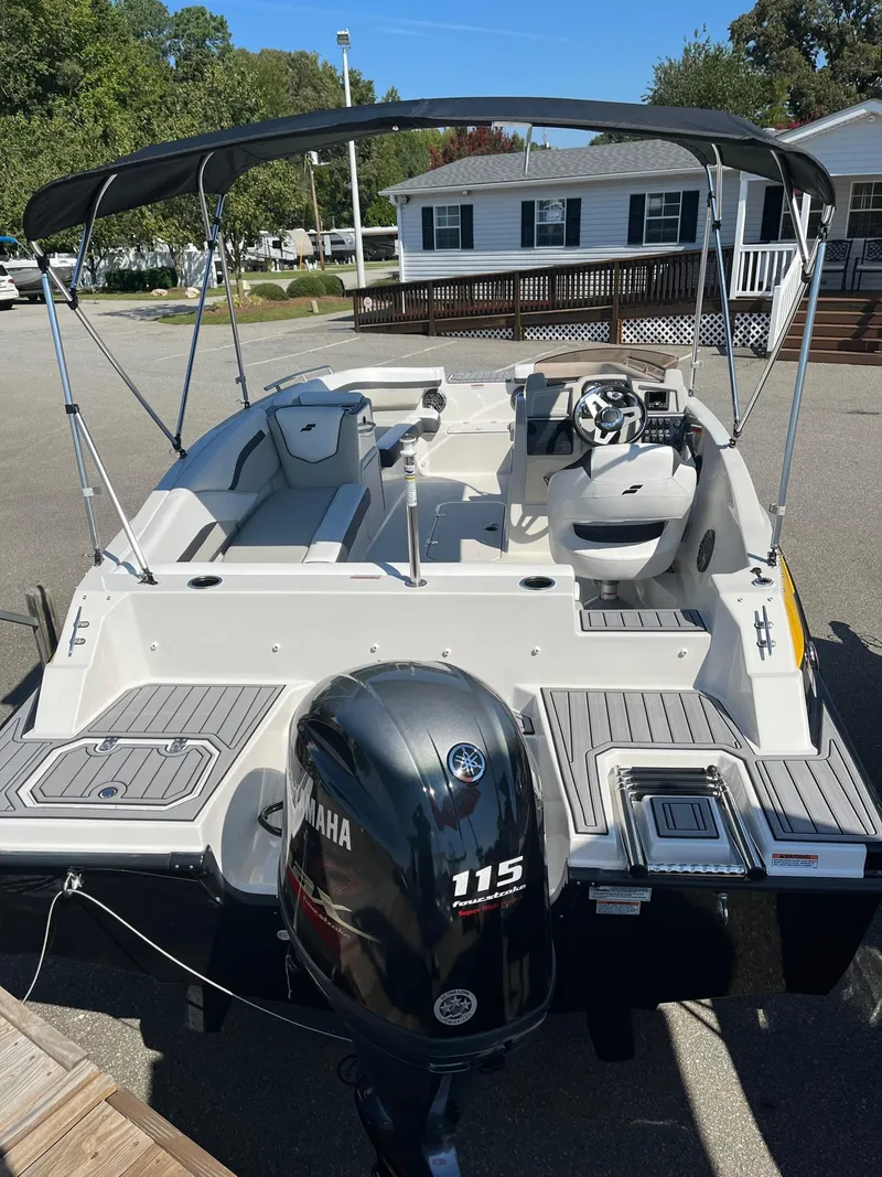Slide: The Image of 2024 Starcraft SVX 191 boat with Yamaha 115 outboard motor, docked in a residential area. - 3