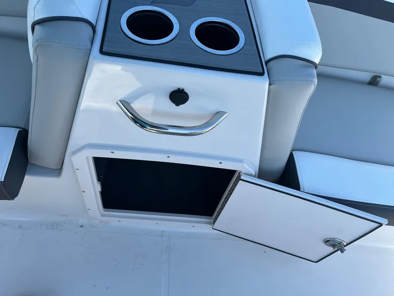 Slide: The Image of 2024 Starcraft SVX 191 boat interior with open storage compartment and cup holders. - 15
