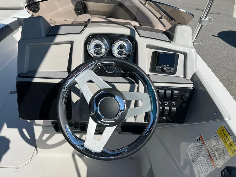 Slide: The Image of 2024 Starcraft SVX 191 boat dashboard with steering wheel and gauges. - 10