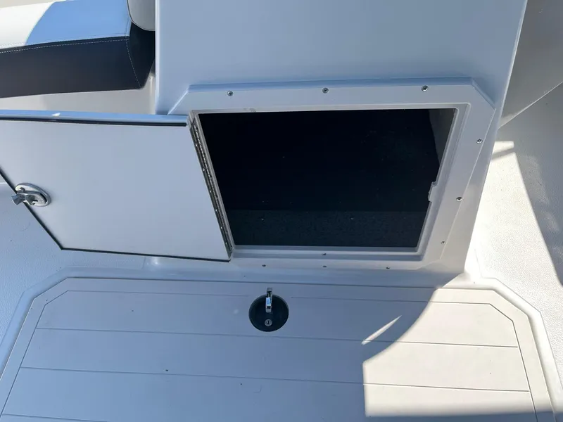 Slide: The Image of 2024 Starcraft SVX 191 boat storage compartment with open door. - 16