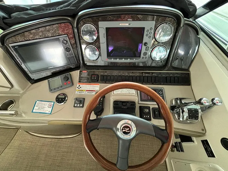 Slide: The Image of 2008 Sea Ray 38 Sundancer helm with navigation screens and controls. - 13