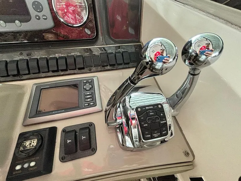 Slide: The Image of Control panel of a 2008 Sea Ray 38 Sundancer boat with throttle levers and navigation display. - 14