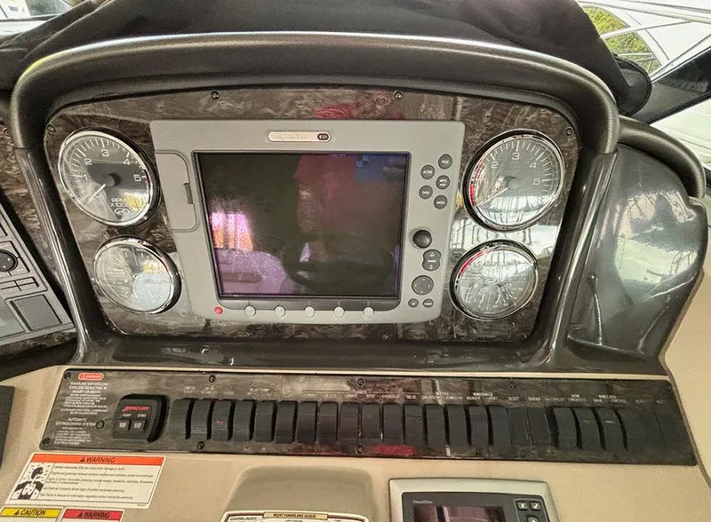 Slide: The Image of Control panel of a 2008 Sea Ray 38 Sundancer boat with gauges and display. - 15