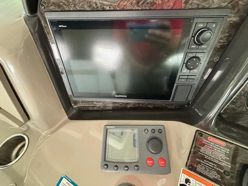Slide: The Image of 2008 Sea Ray 38 Sundancer dashboard with Garmin and Raymarine navigation systems. - 16
