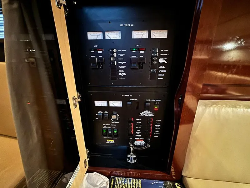 Slide: The Image of Electrical panel inside 2008 Sea Ray 38 Sundancer yacht, showcasing control switches and meters. - 26
