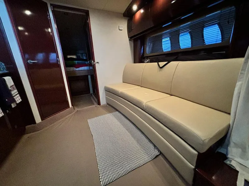 Slide: The Image of Interior of 2008 Sea Ray 38 Sundancer yacht with beige seating and modern decor. - 27
