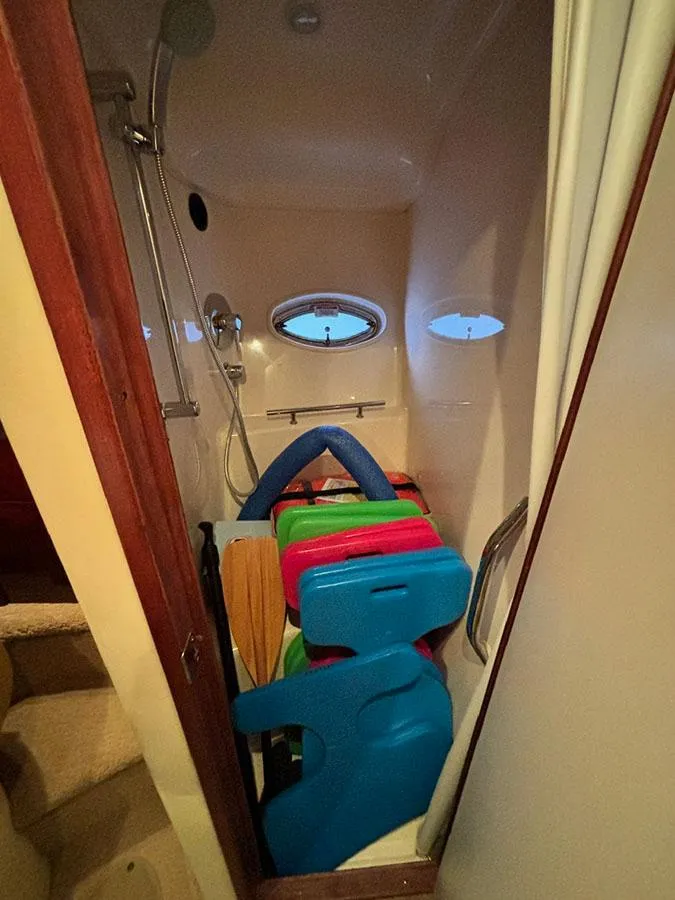 Slide: The Image of Shower area in 2008 Sea Ray 38 Sundancer, filled with colorful pool floats. - 29